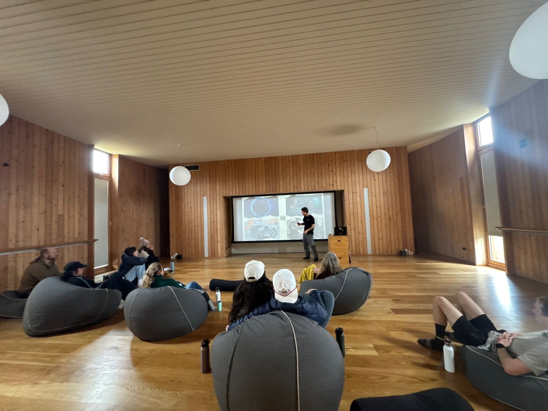 Bitcoin talk in a wooden hall, beanbag audience
